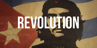 Photo of Cuba flag with silhouette in front. The word 'Revolution' is in the middle of the photo