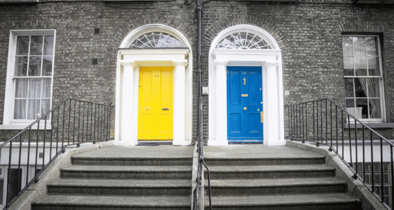 Two staircases. One leading to a yellow door and one leading to a blue door.